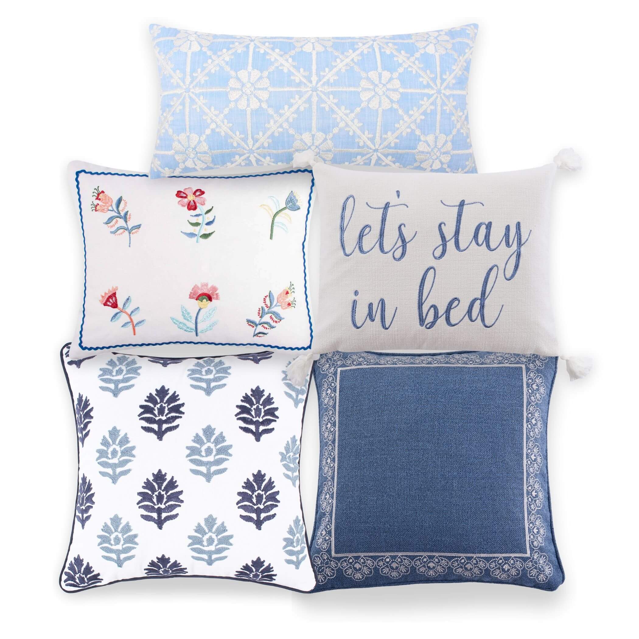 A collection of blue and white throw pillows with various patterns including floral and geometric designs.