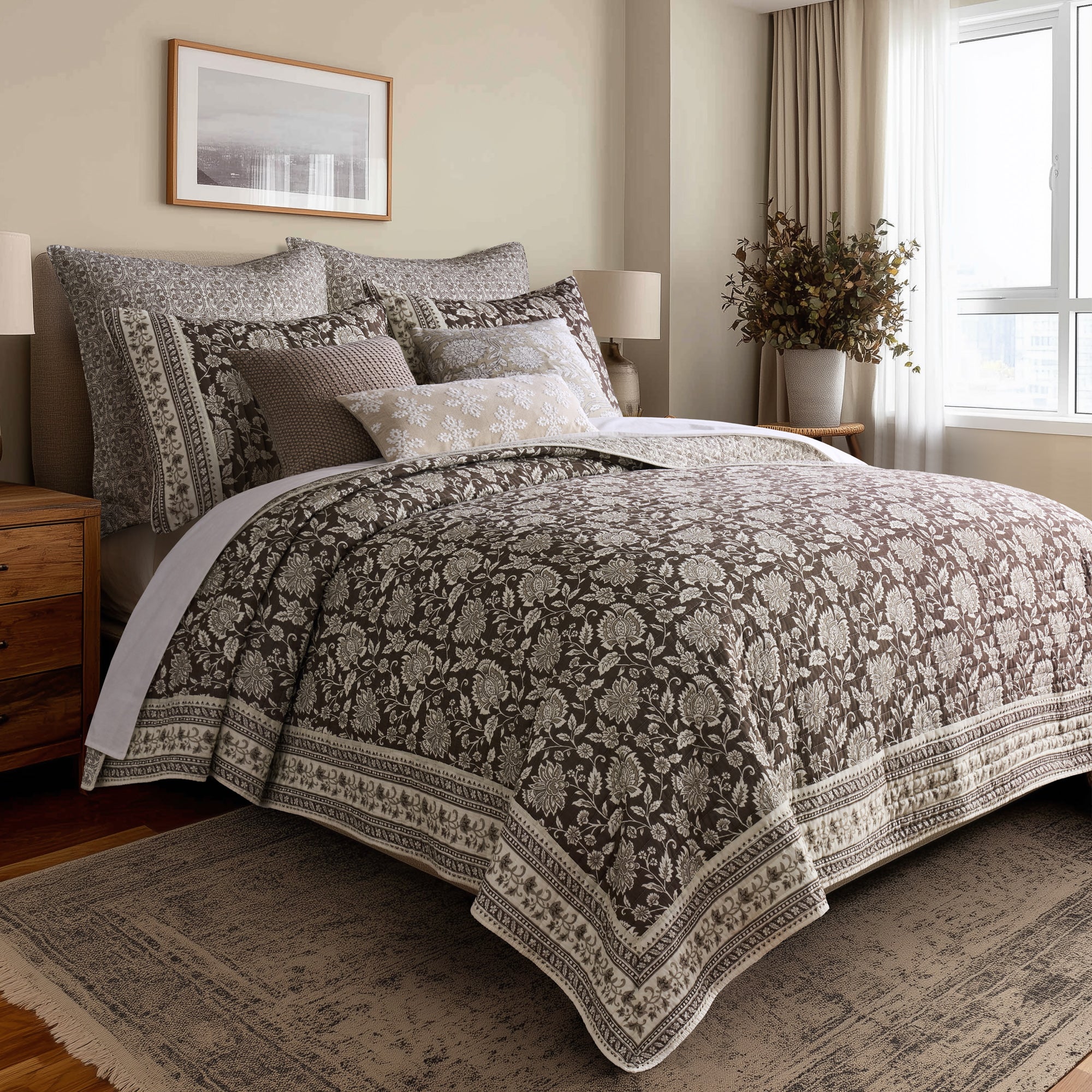Adare Cocoa Quilt Set displayed on a bed, featuring a floral print in cocoa color and reversible design, 100% cotton.