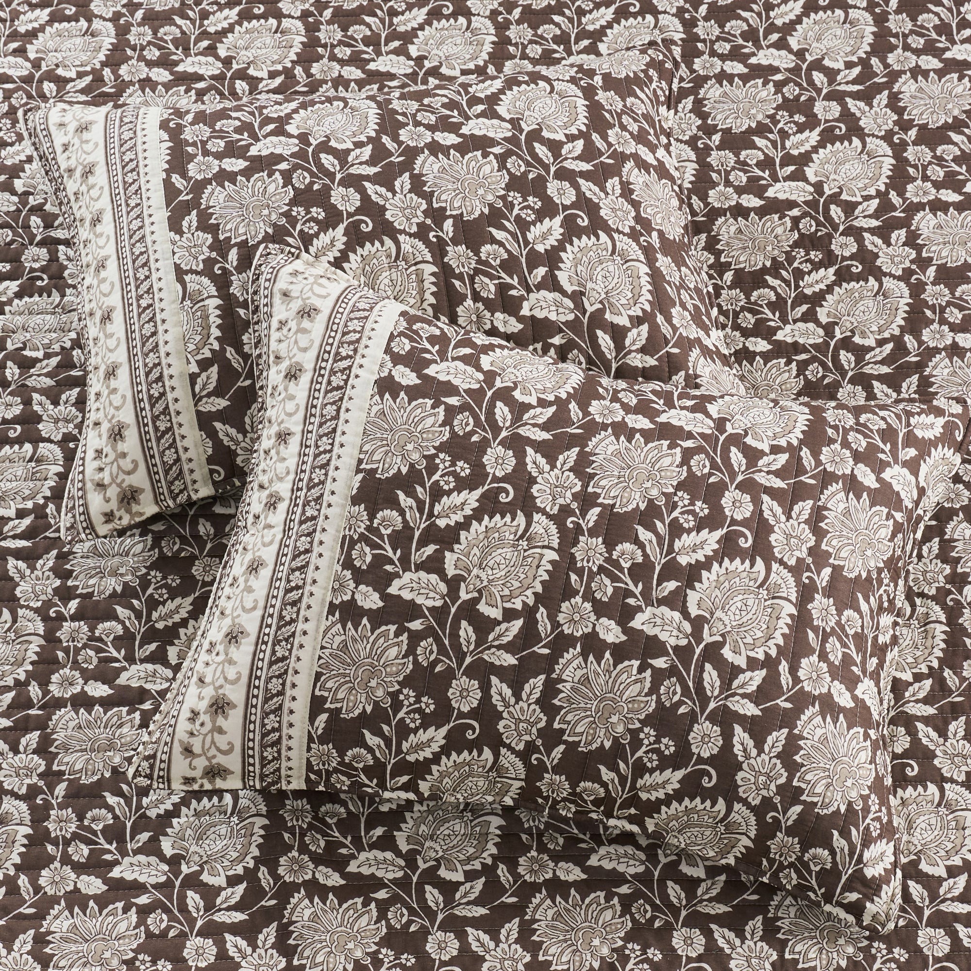 Adare Cocoa Quilt Set featuring floral print pillows on a rich cocoa colored reversible quilt.