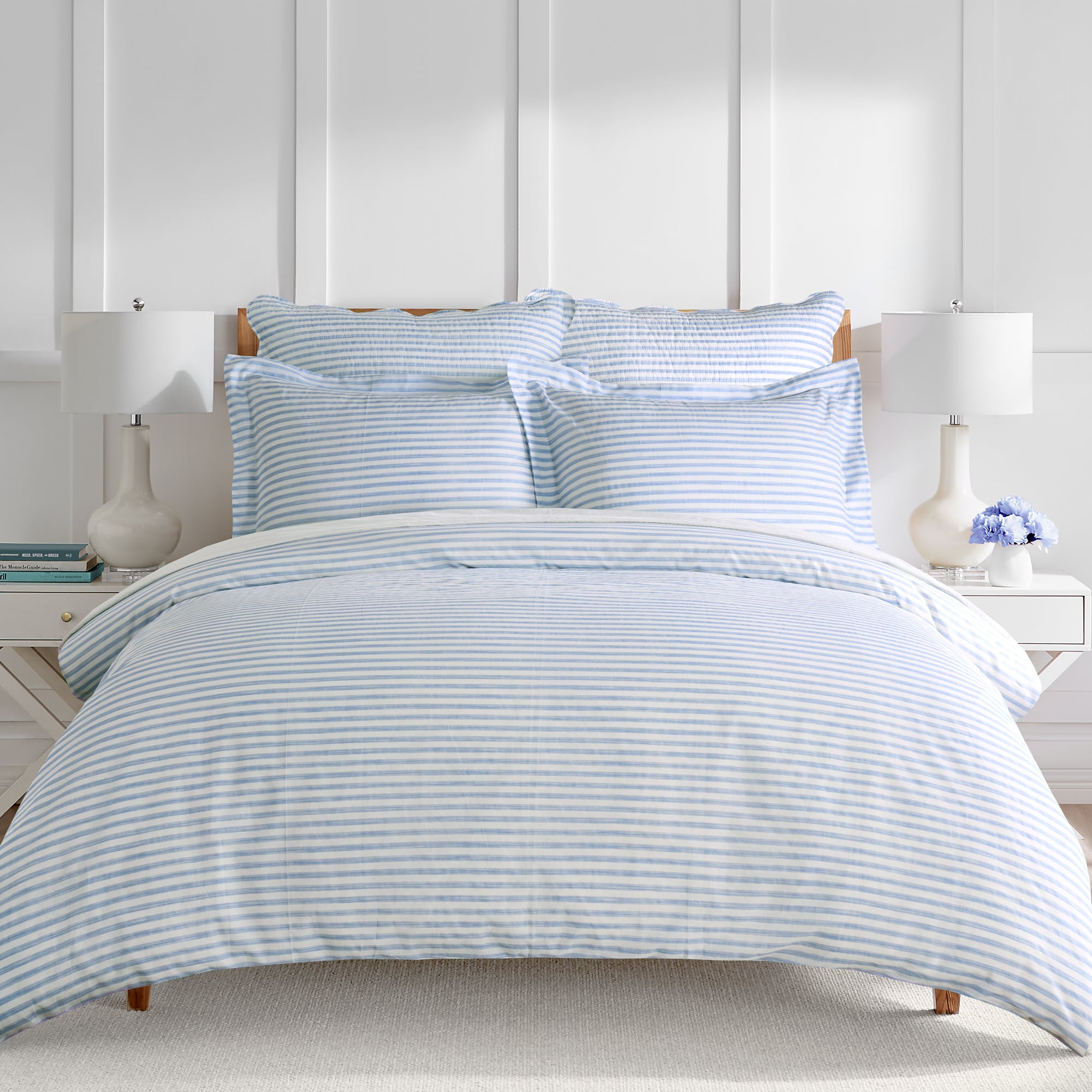 Martha Stripe Blue Duvet Cover Set featuring classic blue and white stripes on a bed with decorative pillows and lamps.