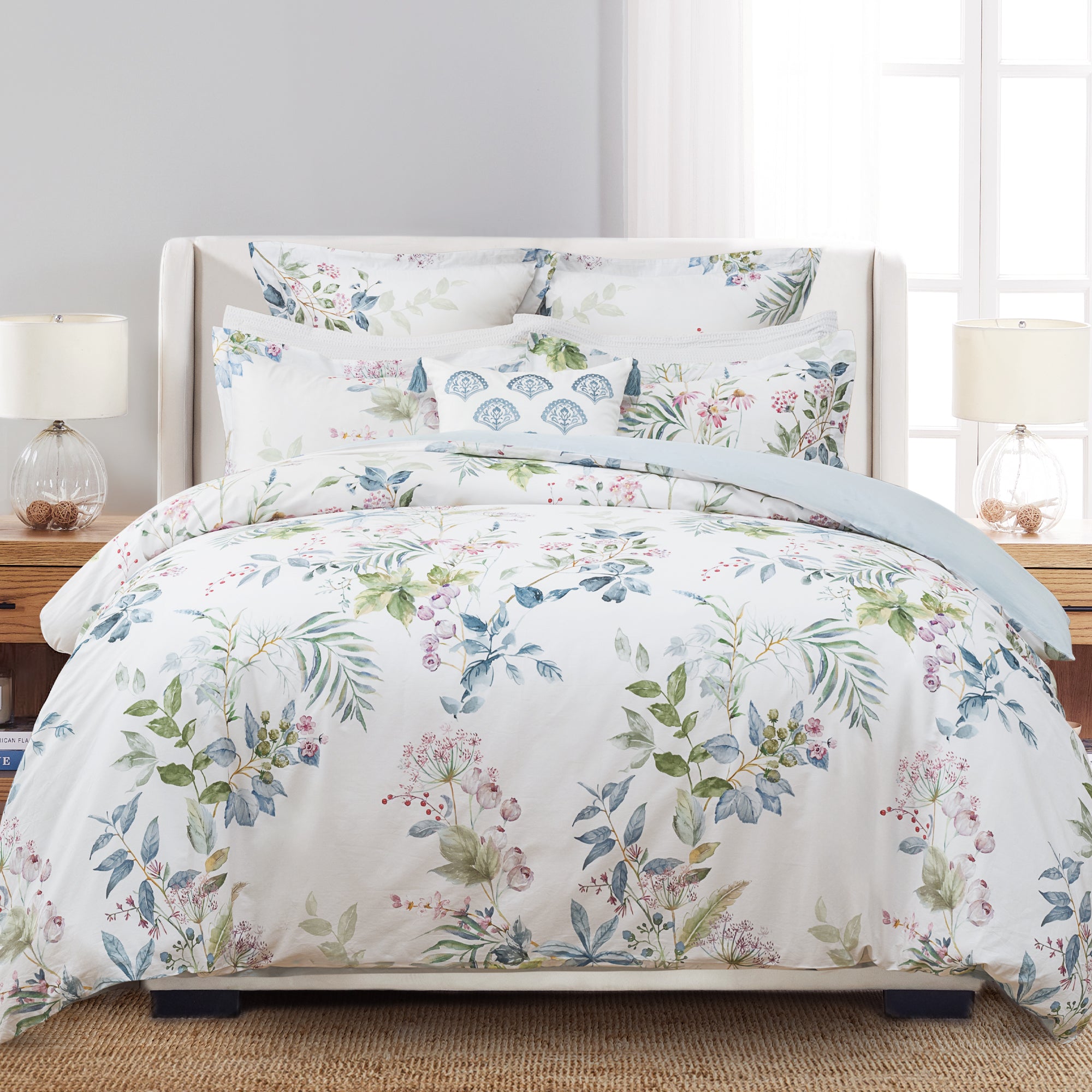 Seraphine Blooms Duvet Cover Set displayed on a bed with floral design and matching pillow shams in a stylish bedroom setting.