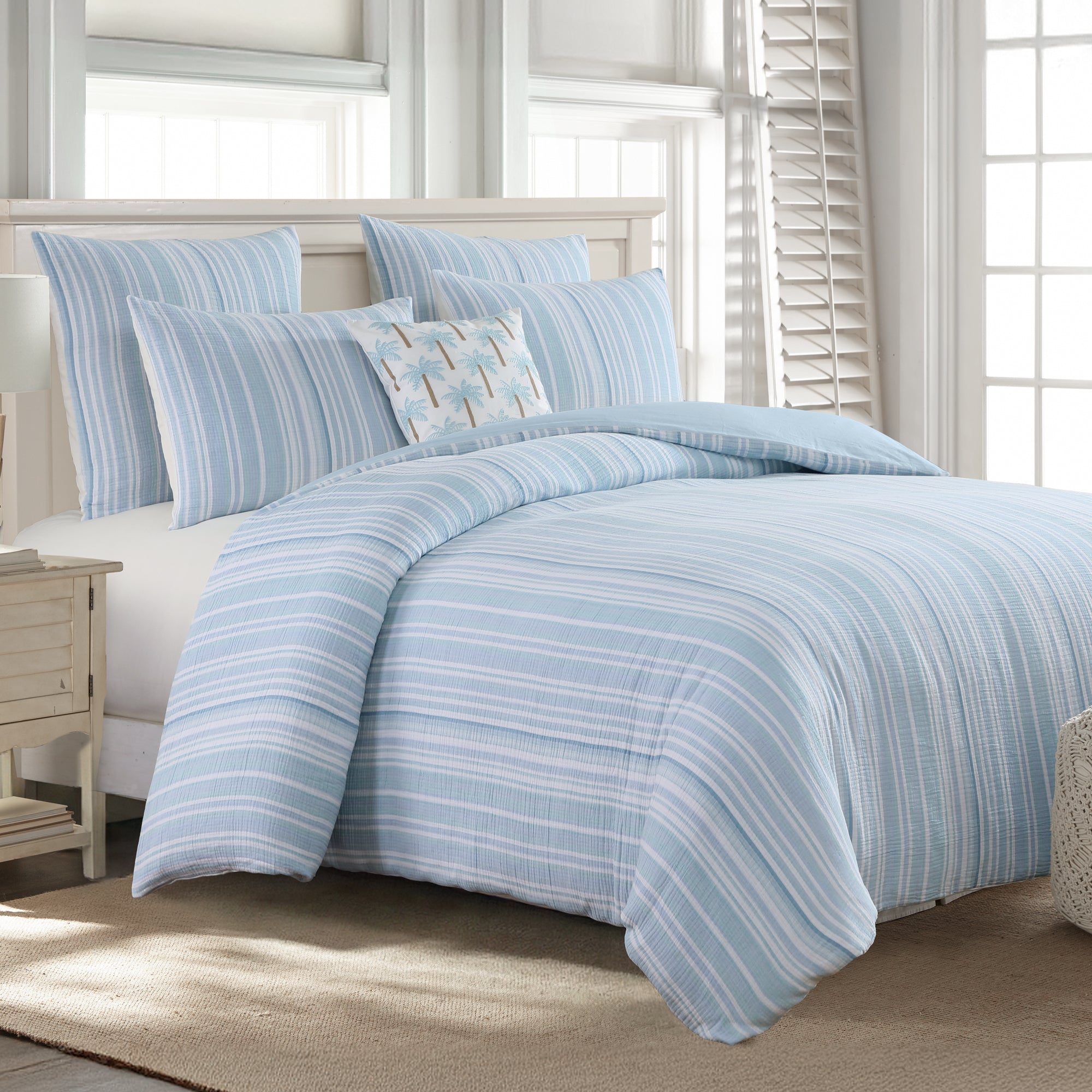 Boracay Stripe Muslin Duvet Cover Set featuring soothing aqua and white striped design on a cozy bed.