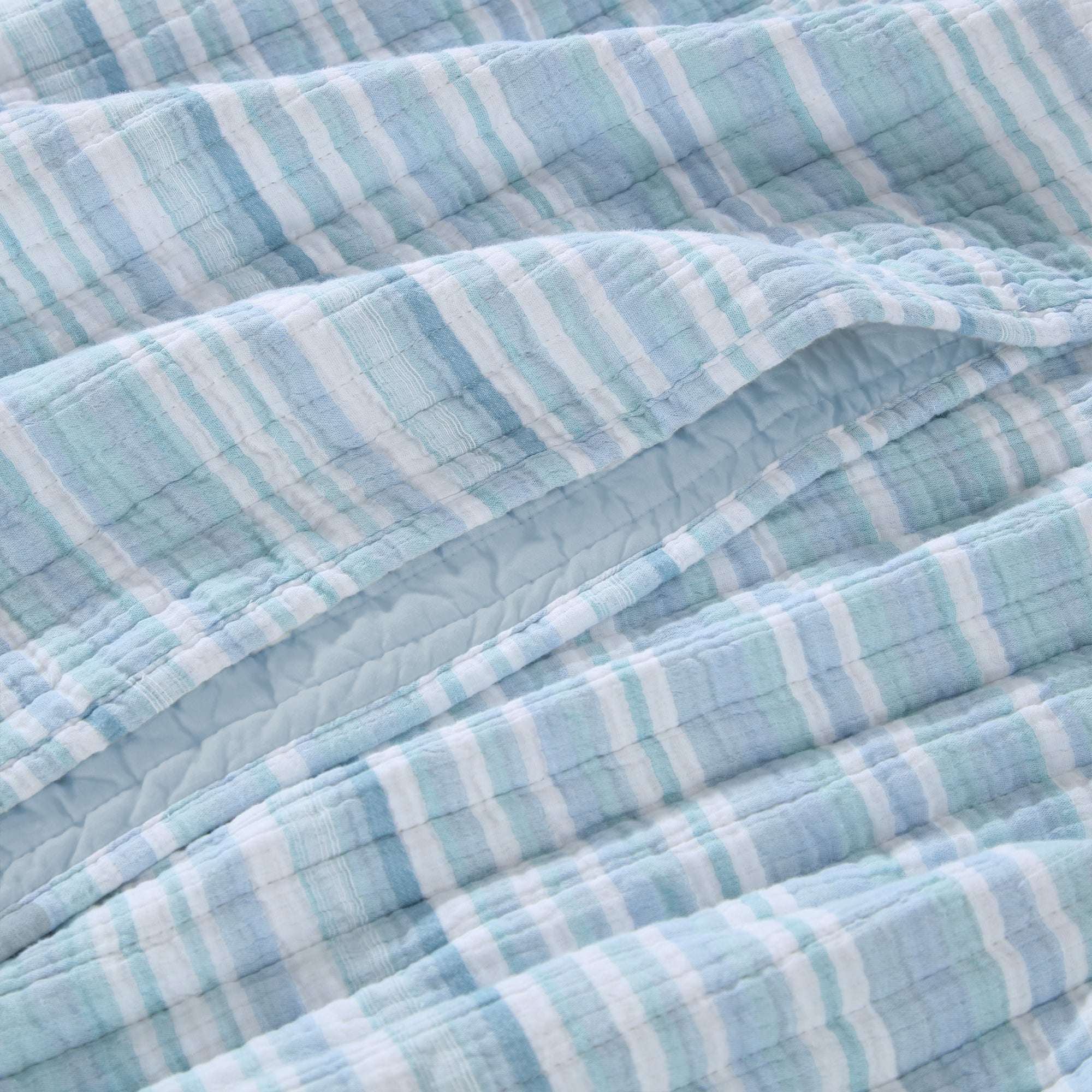 Boracay Stripe Muslin Quilt Set featuring a soft, textured cotton layout in soothing aqua and seafoam stripes.