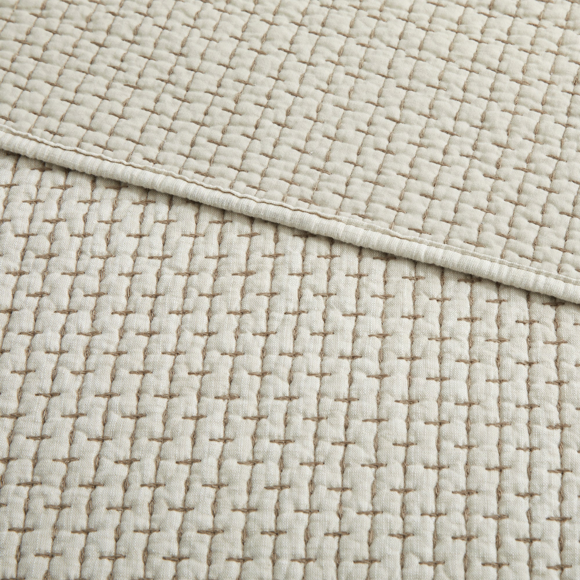 Close-up of the Pick-Stitch Artisan Quilted Throw showcasing detailed pick-stitch texture on cotton slub fabric.
