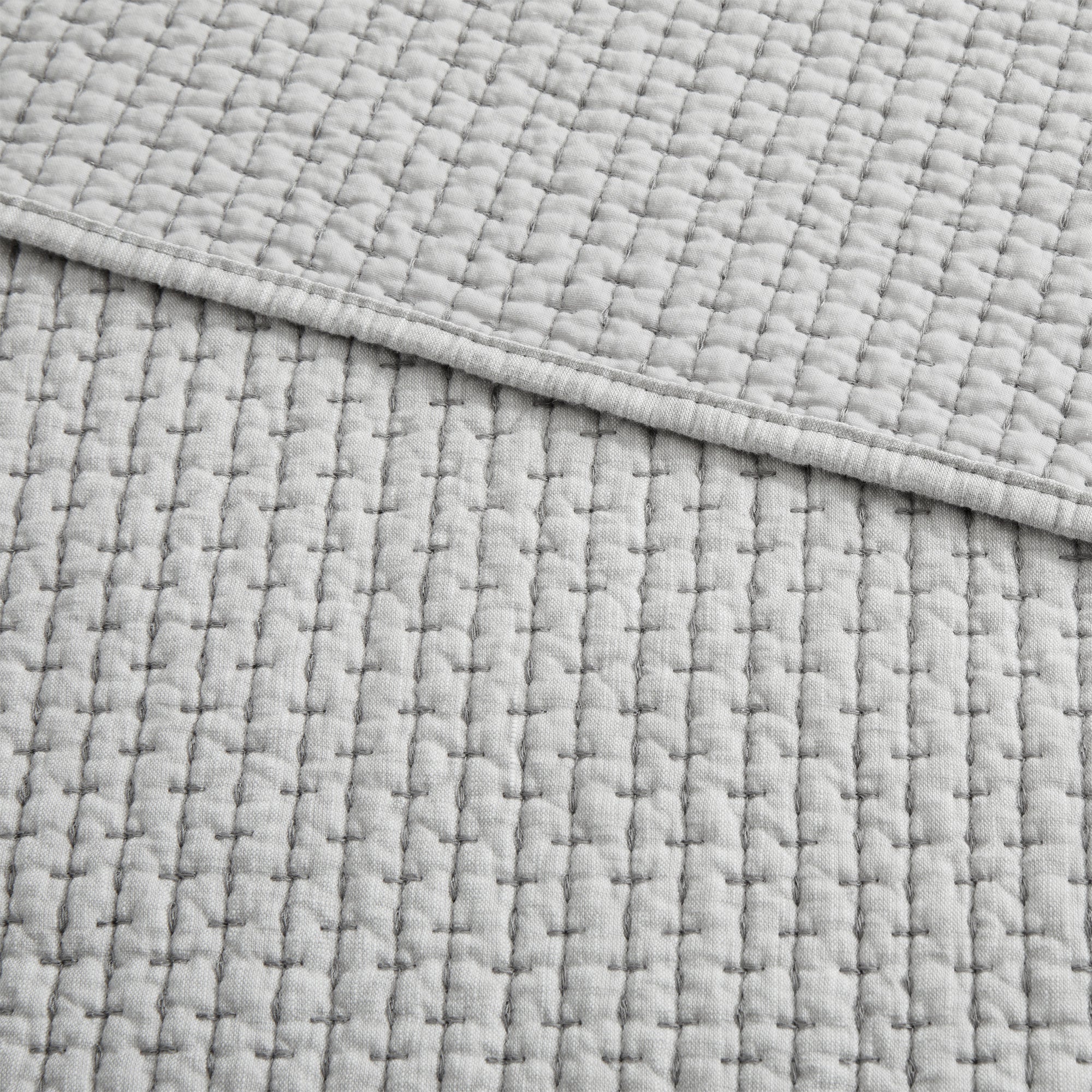 Pick-Stitch Artisan Quilted Throw featuring a textured quilted cotton slub surface with pick-stitch detailing.
