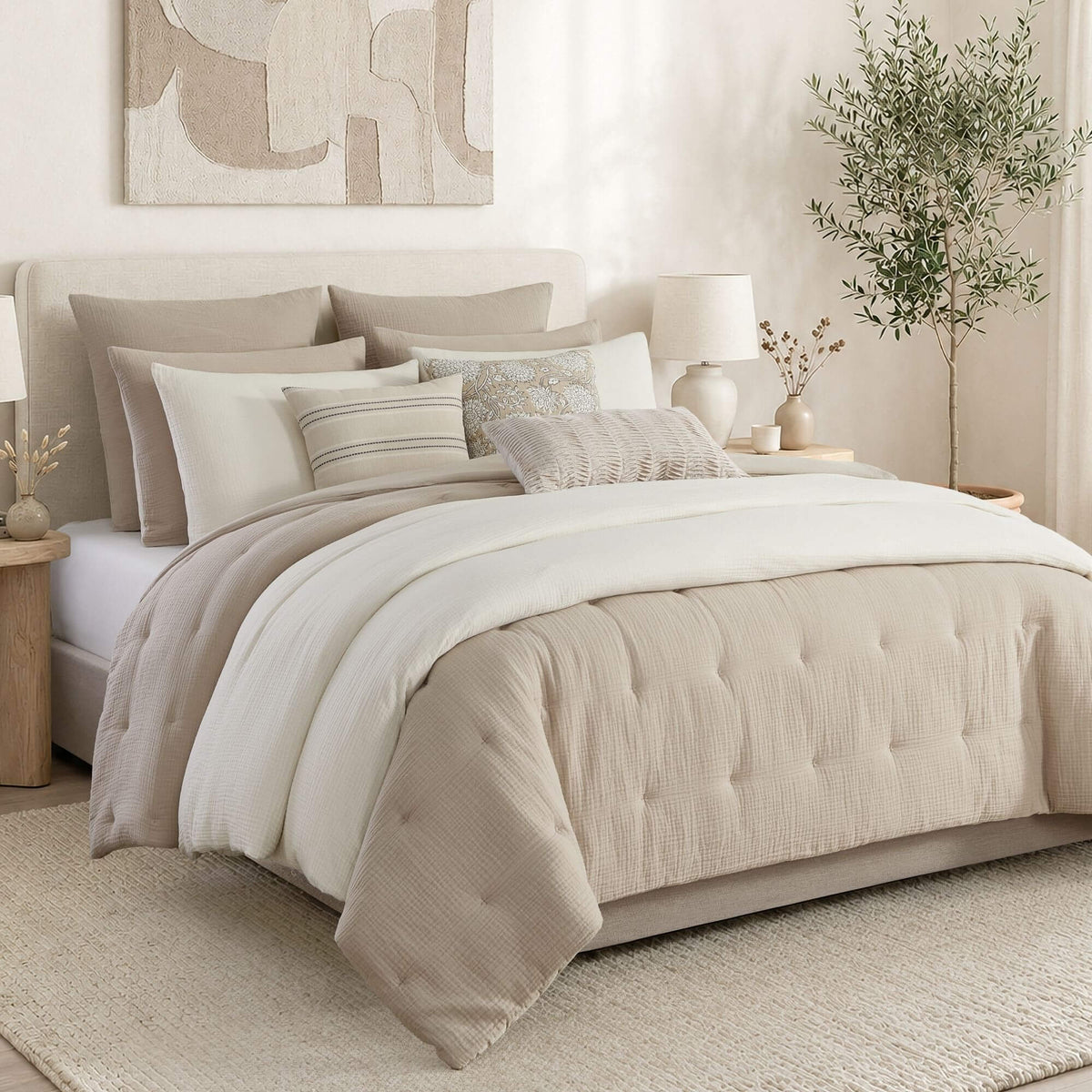 Neatly made bed with beige and white bedding in a bedroom setting.