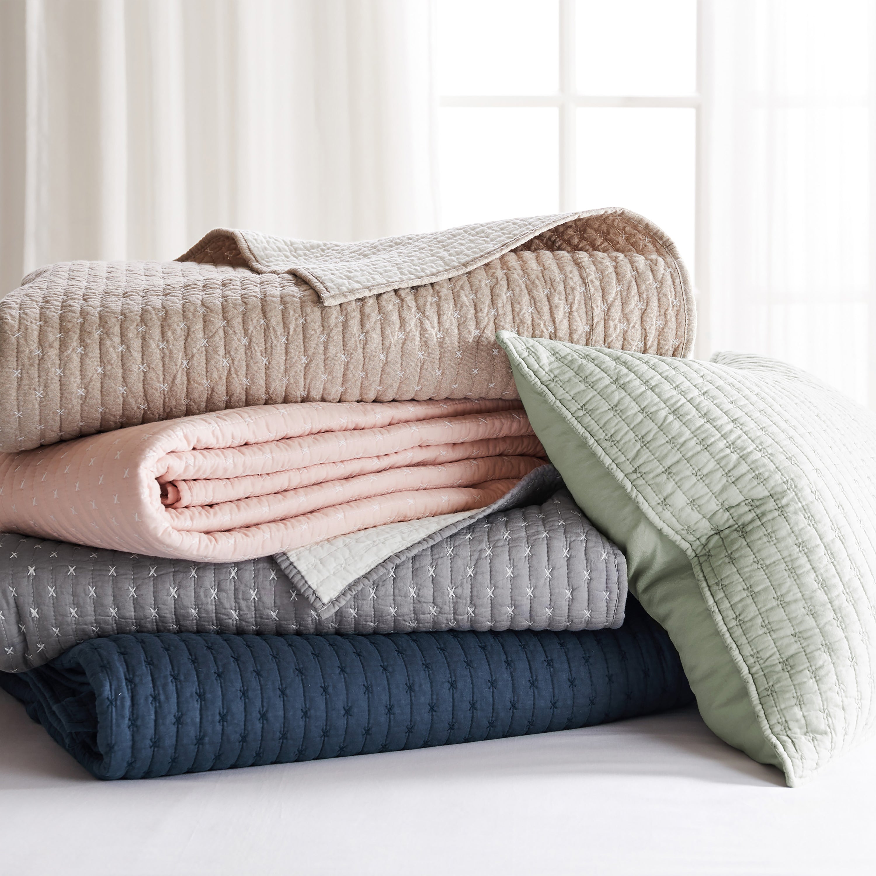 Stack of solid bedding pieces