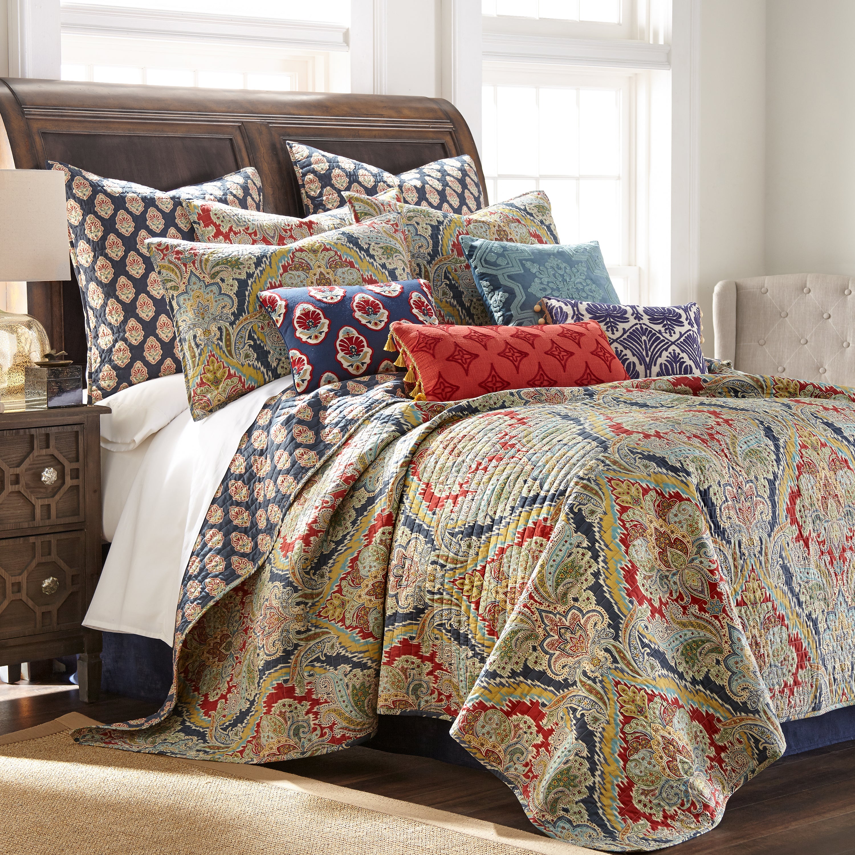Bed featuring damask & medallion bedding and decorative pillows