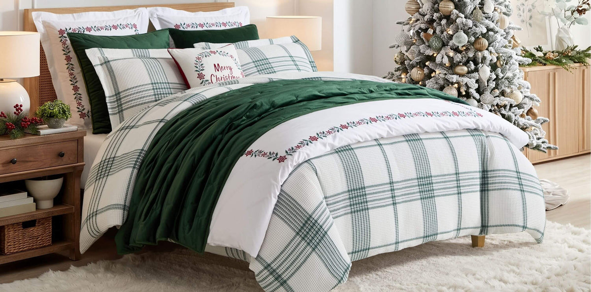 Christmas bedding with green and white plaid duvet, festive pillows, and decorated Christmas tree