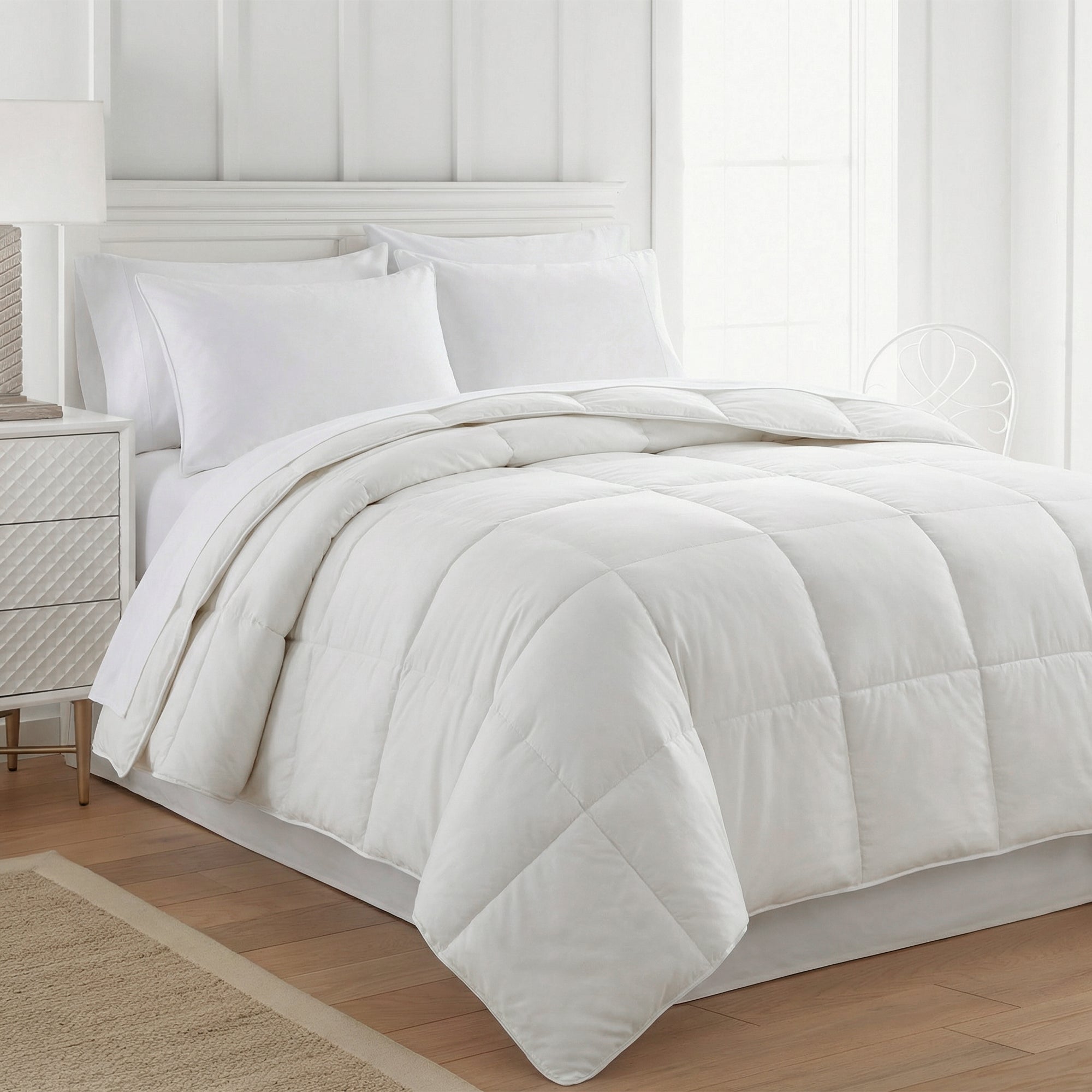 White duvet inner and pillows on a bed in a bright bedroom