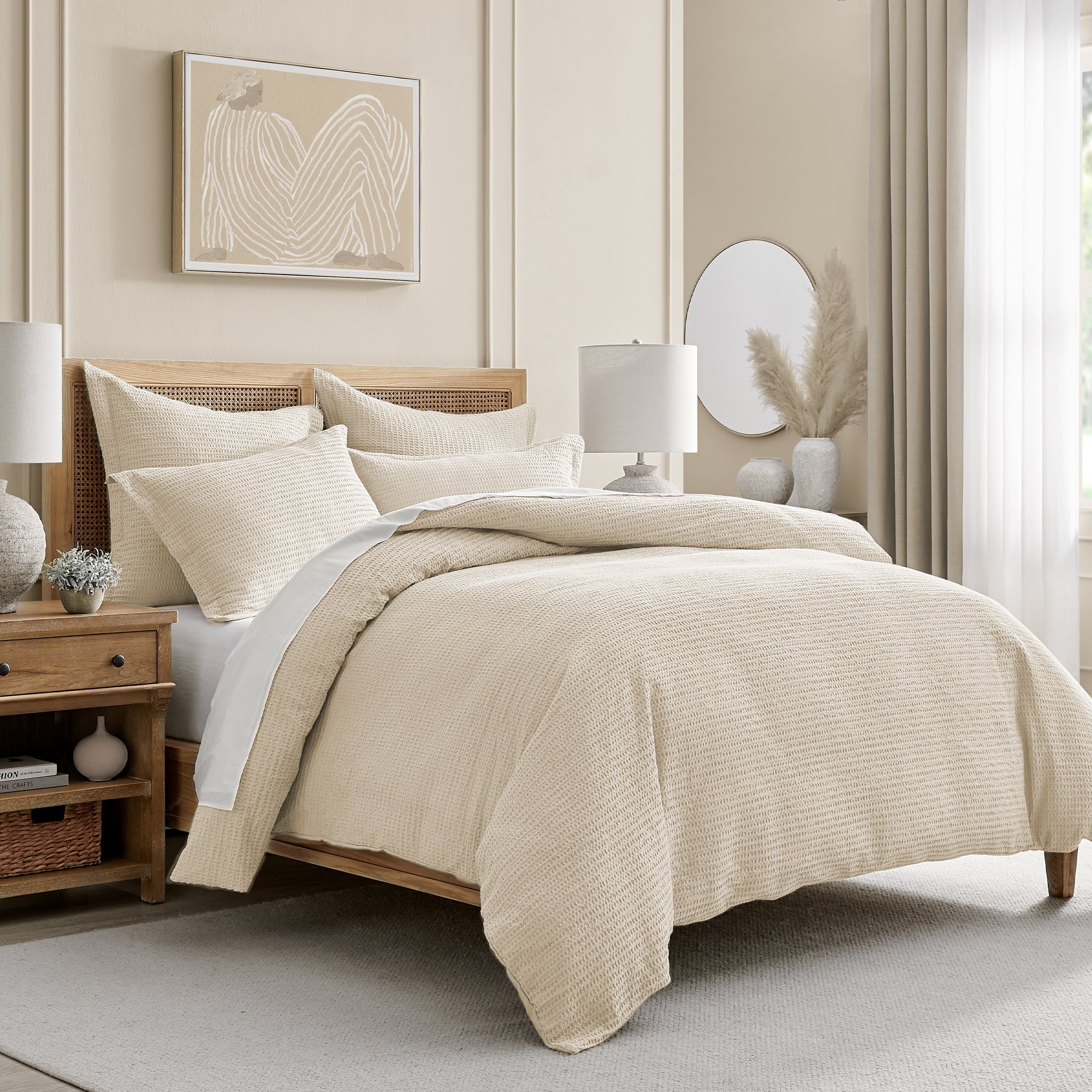 Beige bedroom with a bed, nightstands, and wall art