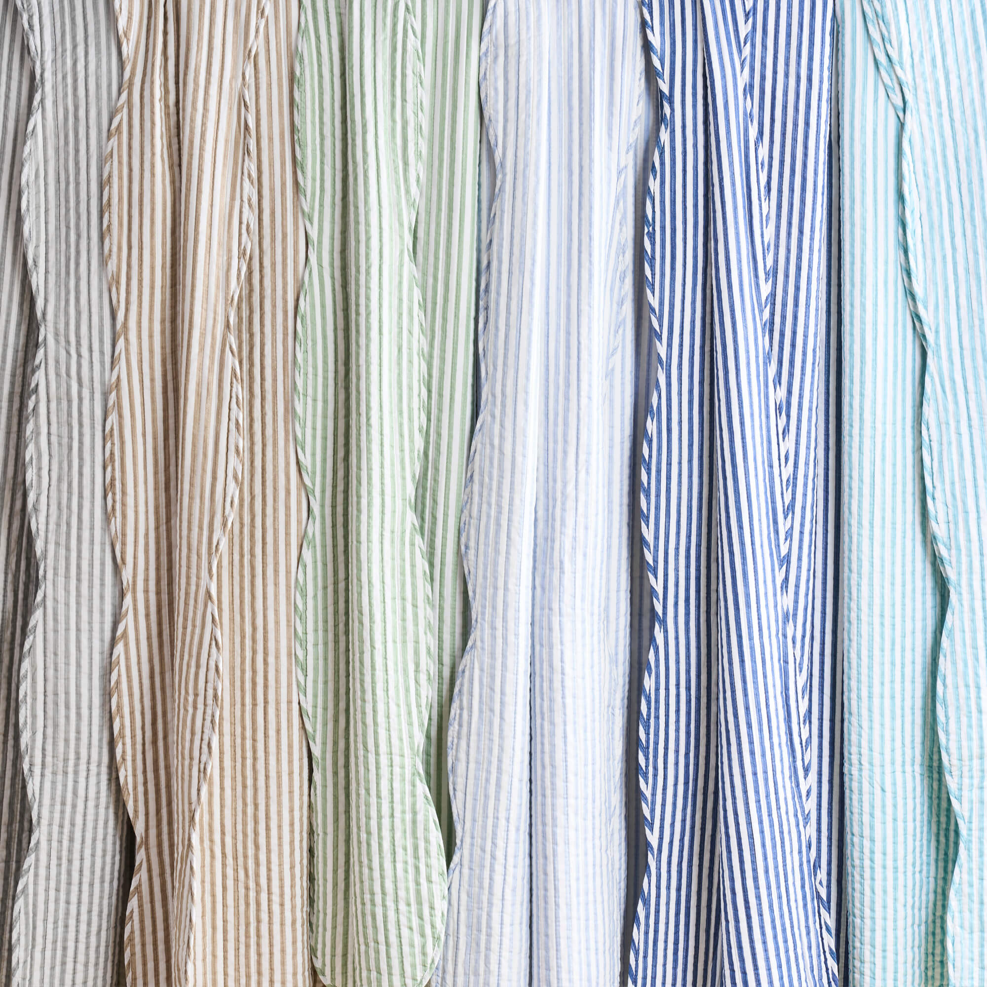 Collection of striped shirts in various colors and patterns.