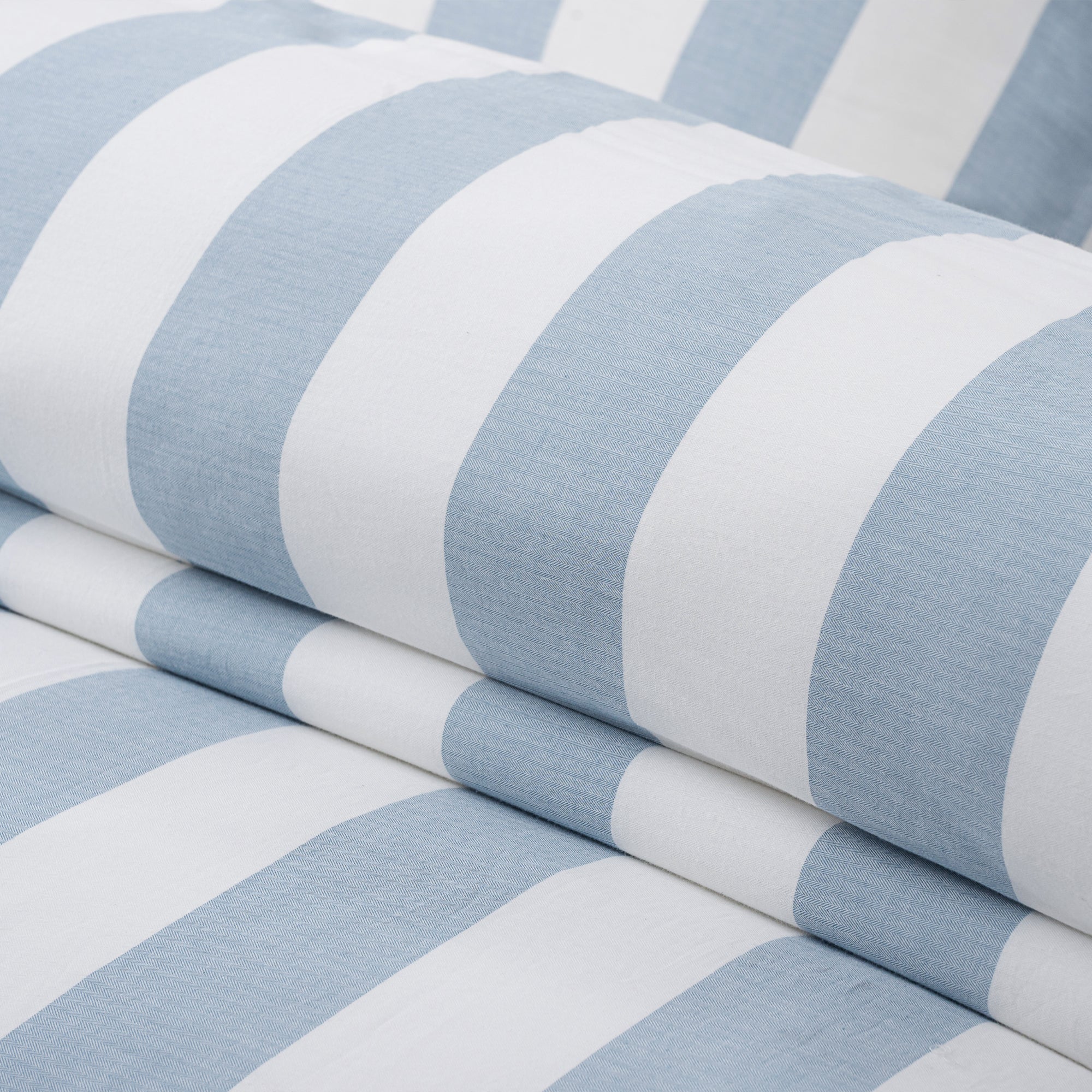 Close-up of Cabana Woven Stripe Comforter Set featuring soft coastal blue and white vertical stripes.