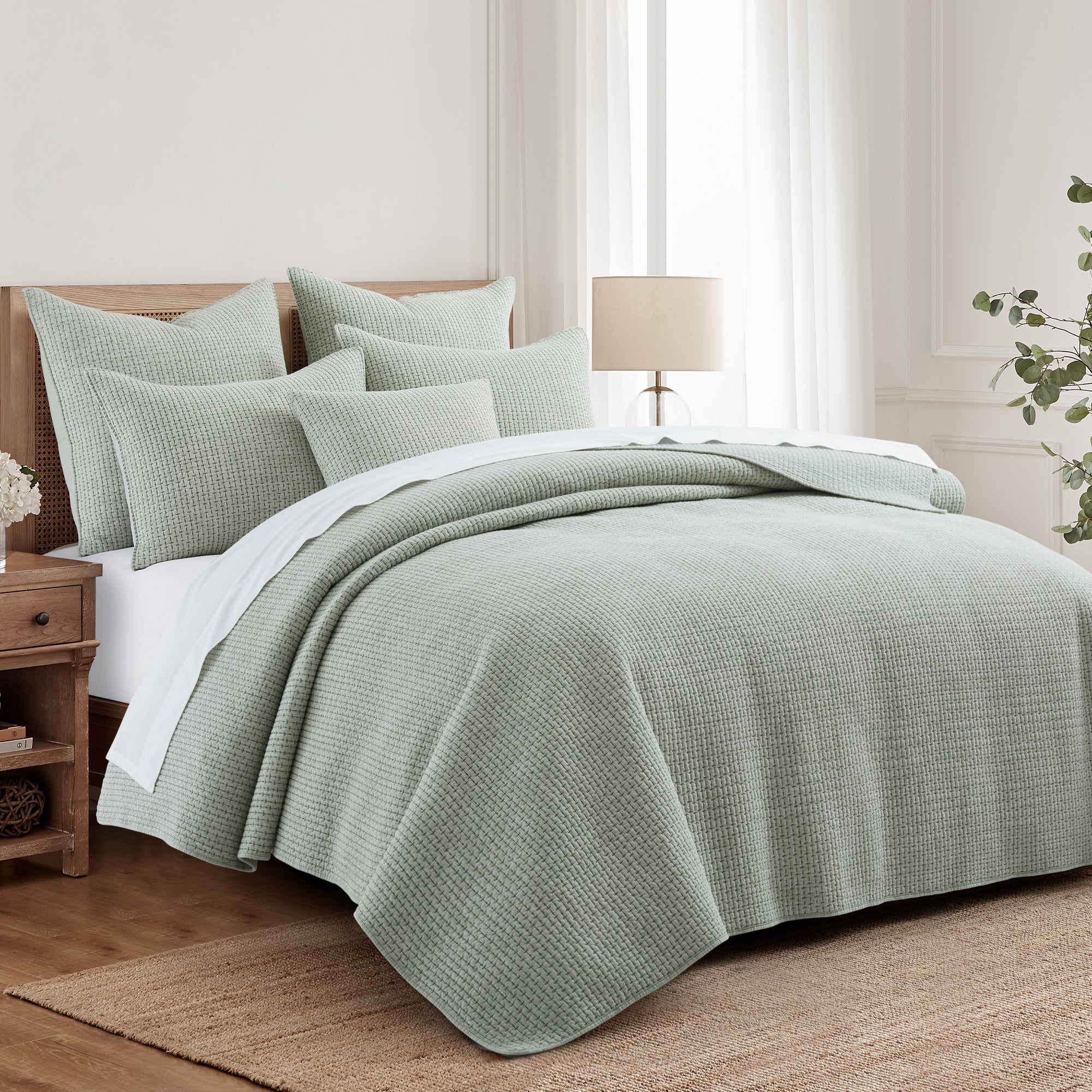 Pick-Stitch Artisan Euro Sham Set of 2 displayed on a cozy bed with layered textures and soft colors.