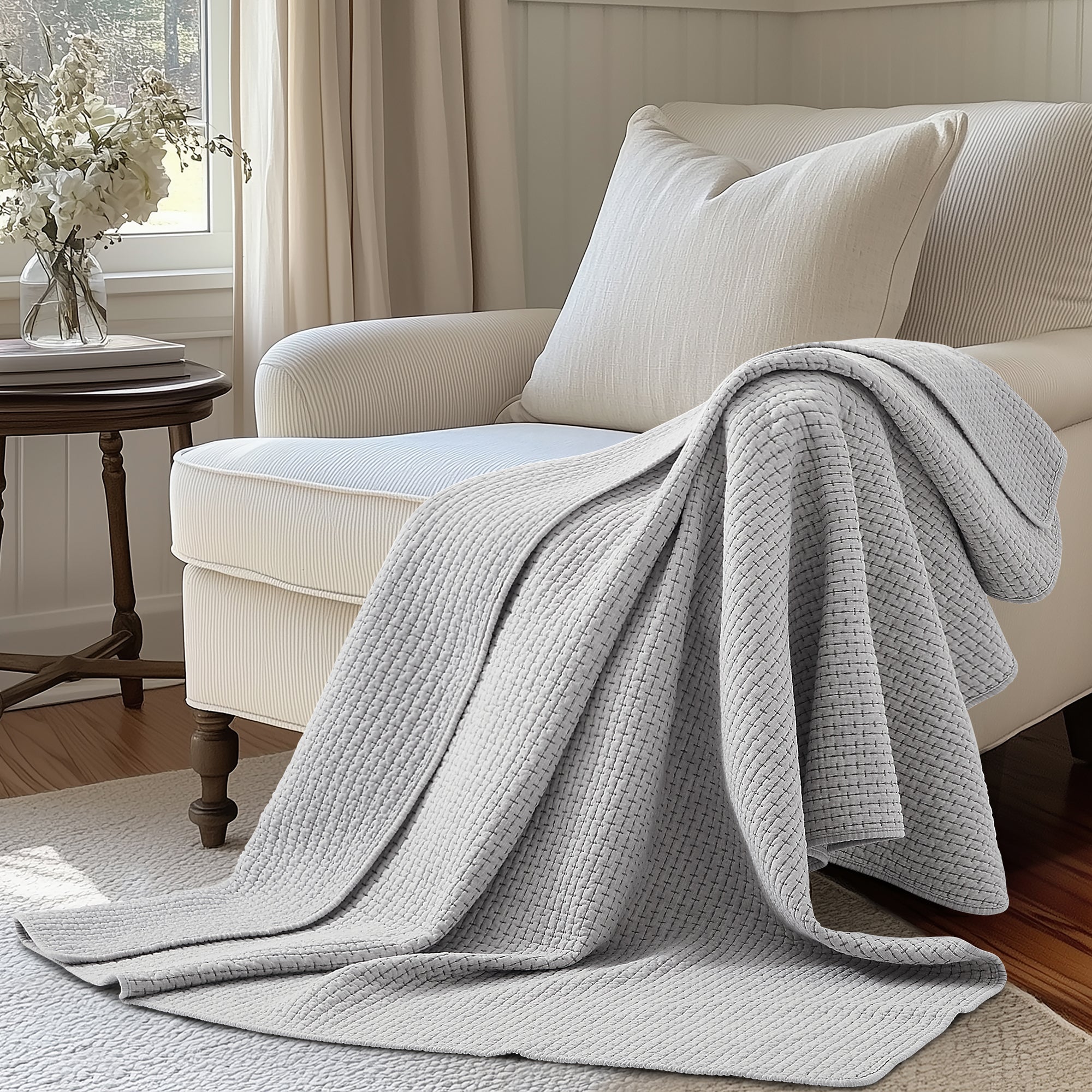 Pick-Stitch Artisan Quilted Throw draped over a cozy chair in a bright, inviting living room setting.
