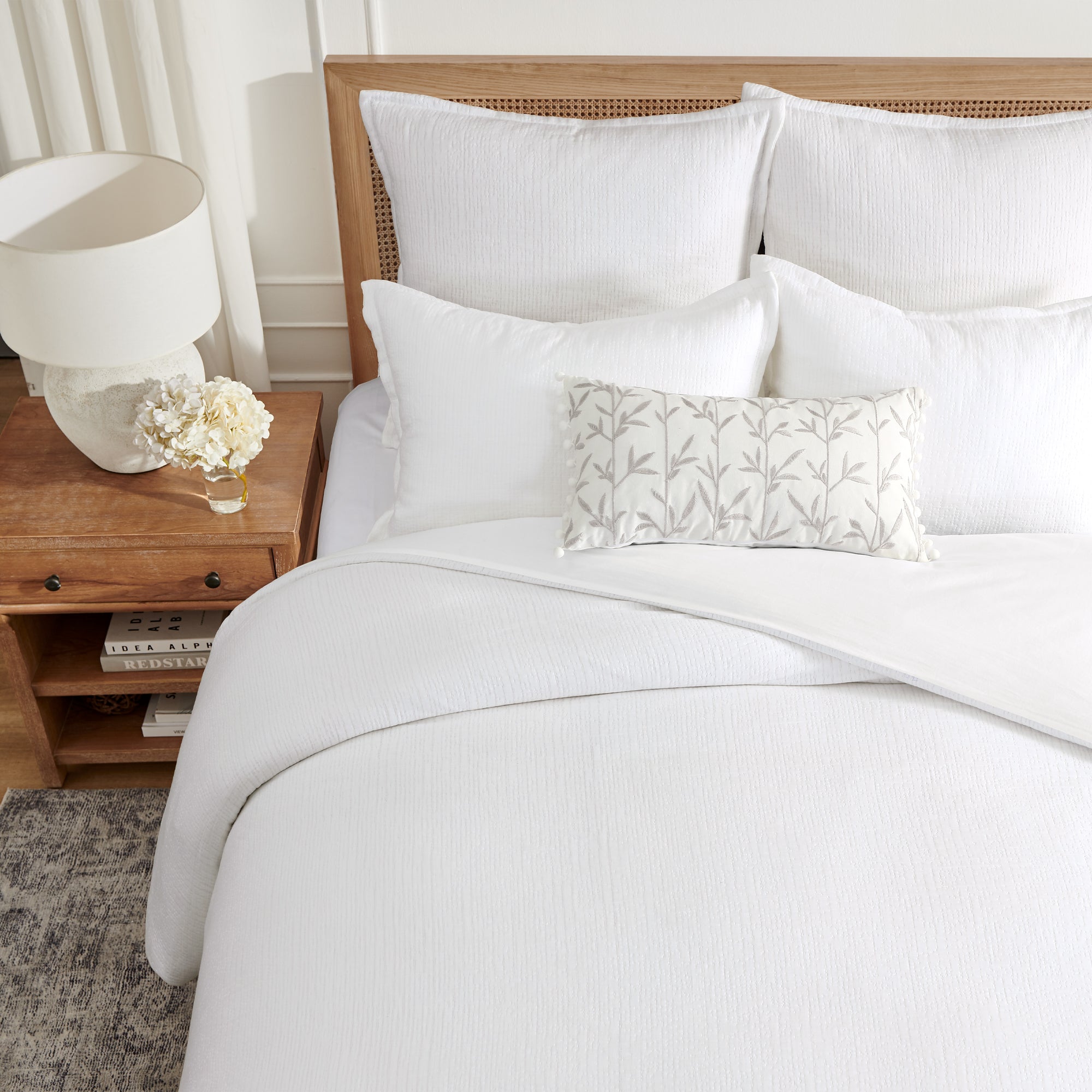 Cotton Tencel Matelasse Comforter Set styled on a bed with white pillows and a decorative pillow on a wooden bed frame.