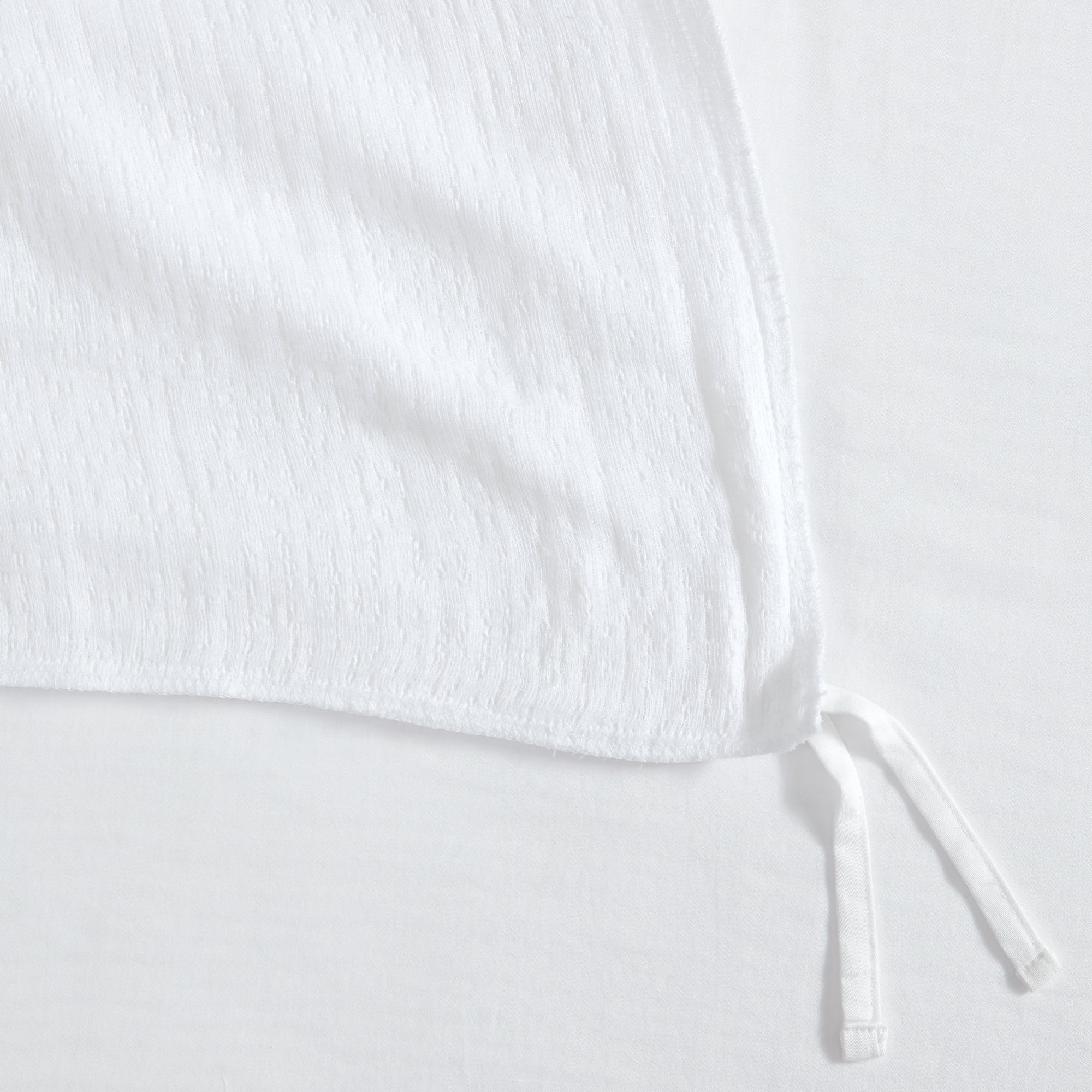 Cotton Tencel Matelasse Duvet Set showing the textured white fabric and corner ties of the duvet cover.
