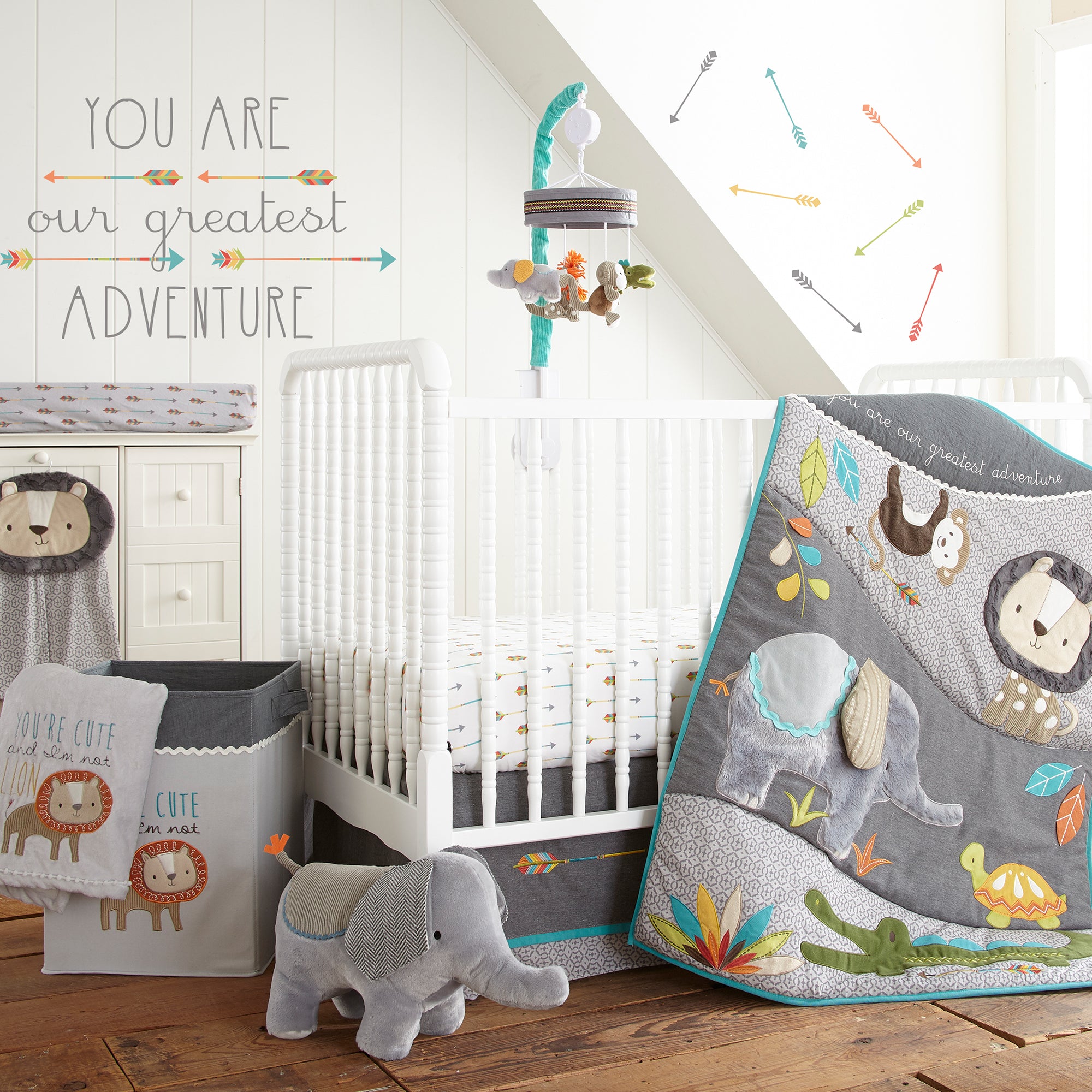 Jungle-safari themed nursery featuring white crib, safari-themed bedding set, and matching decor