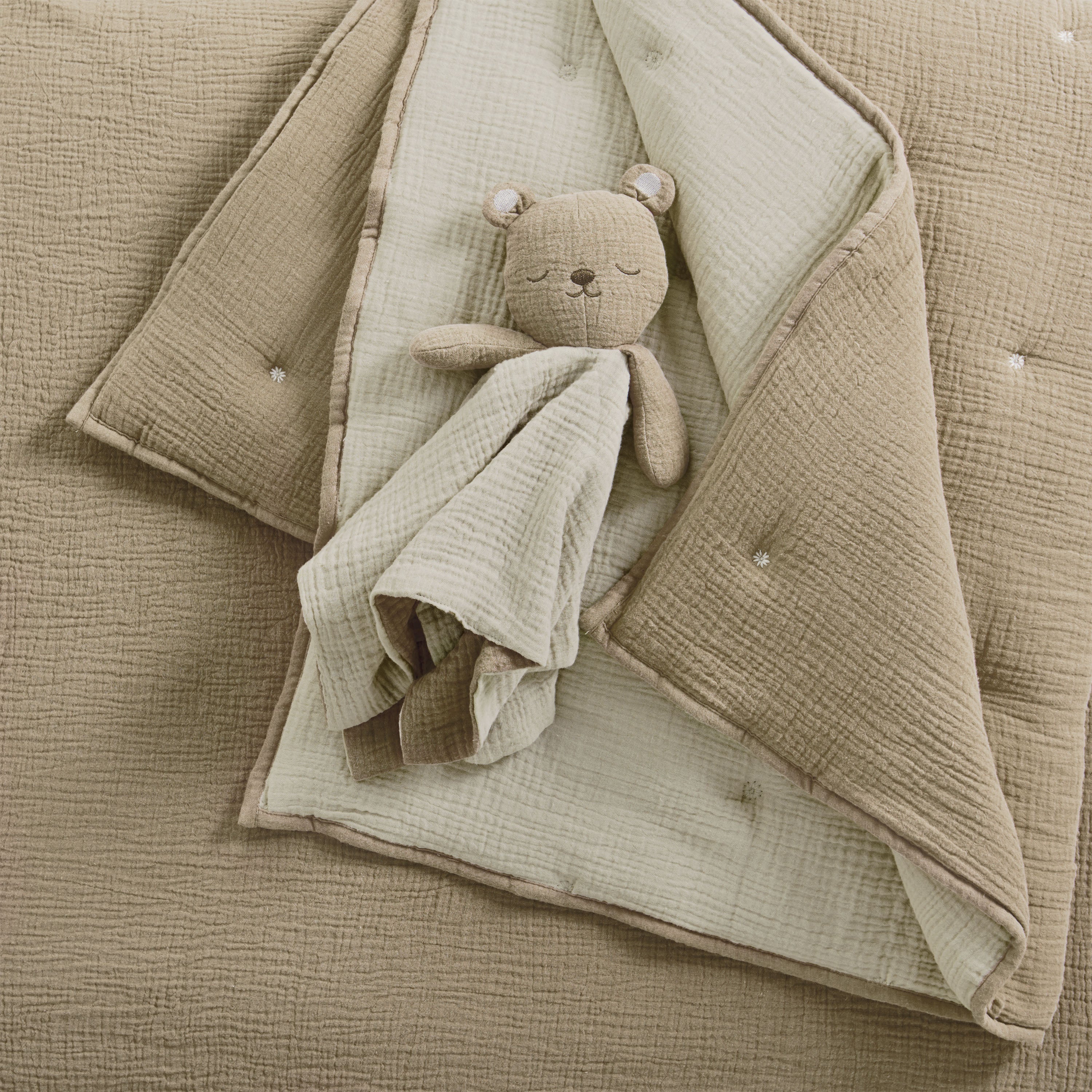 Taupe muslin cotton nursery blanket with a muslin cotton plush bear toy