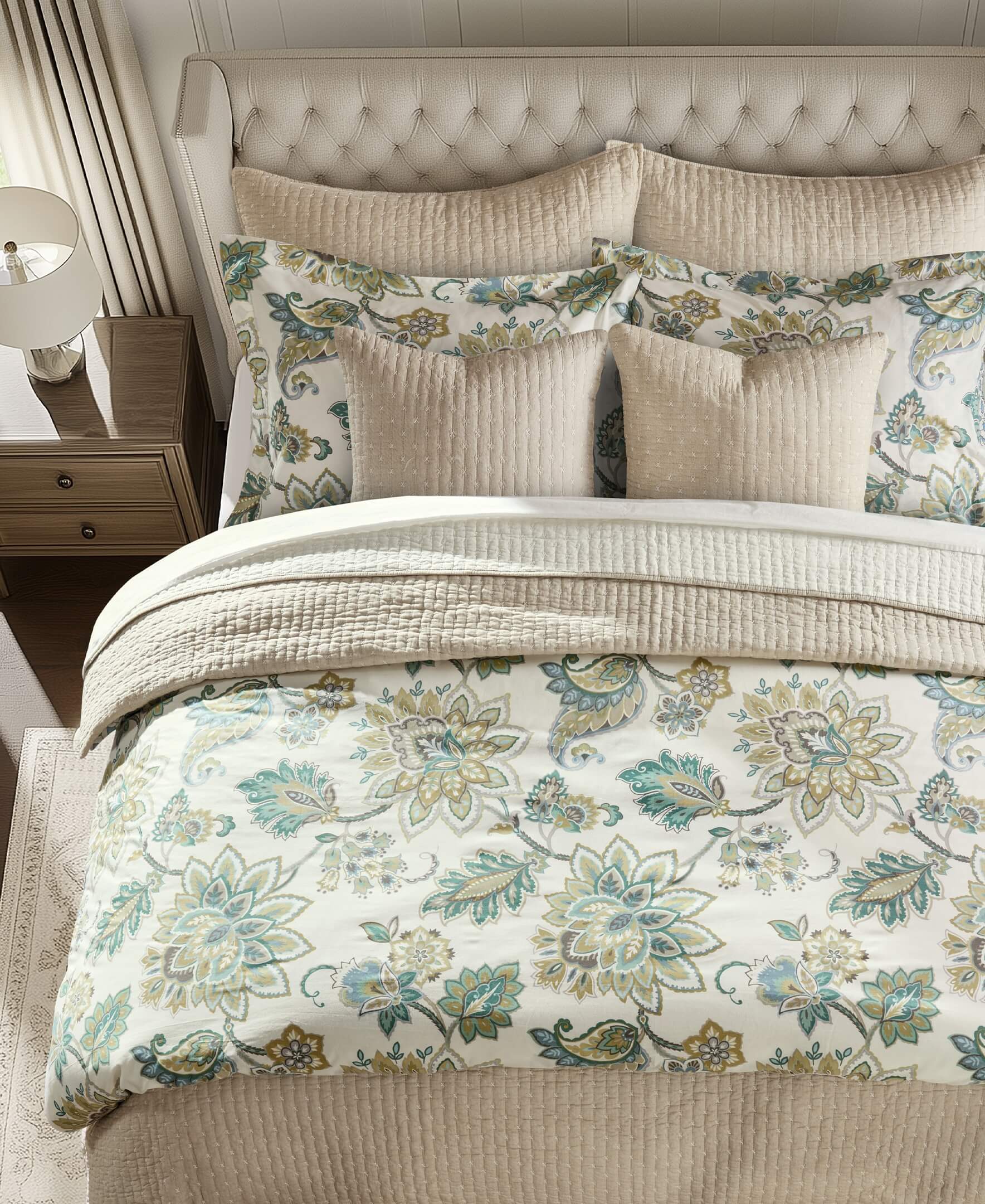 Bed with the Levtex Home Palladium Grey Duvet Cover Set featuring a floral print and pillows in a bedroom setting