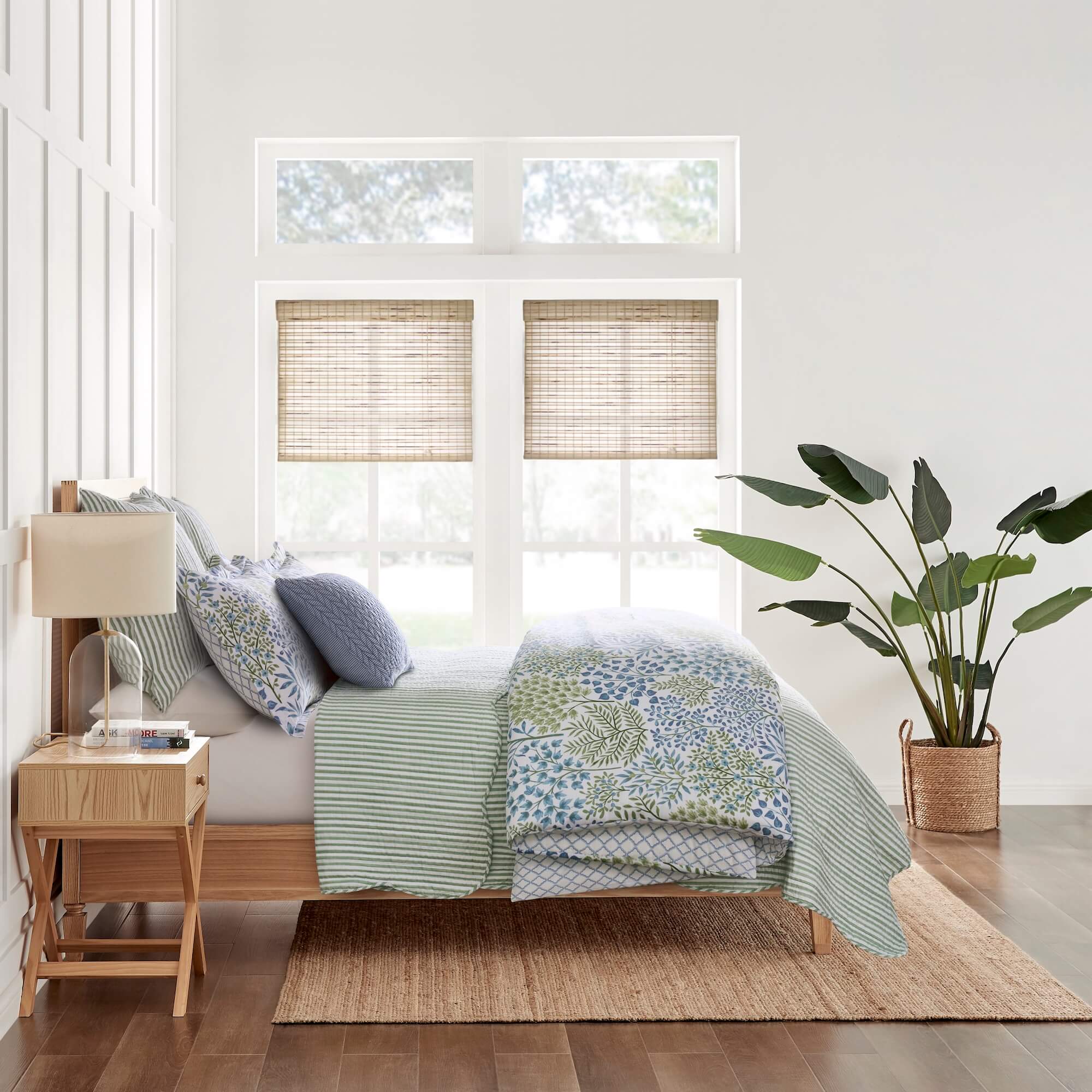 Bedroom with wooden bed, side table, and window blinds