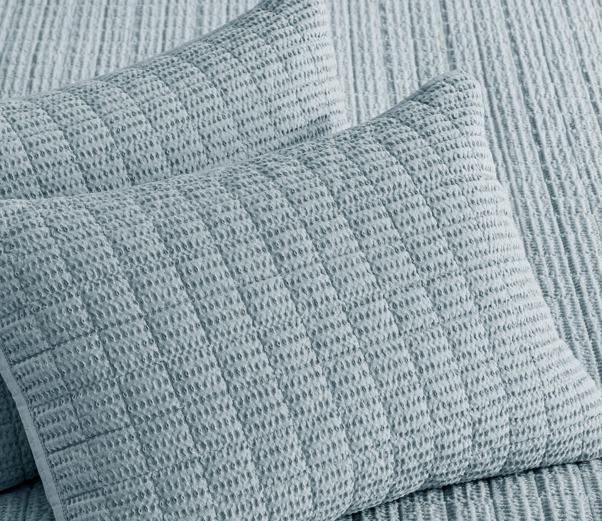Textured blue pillows on a sofa
