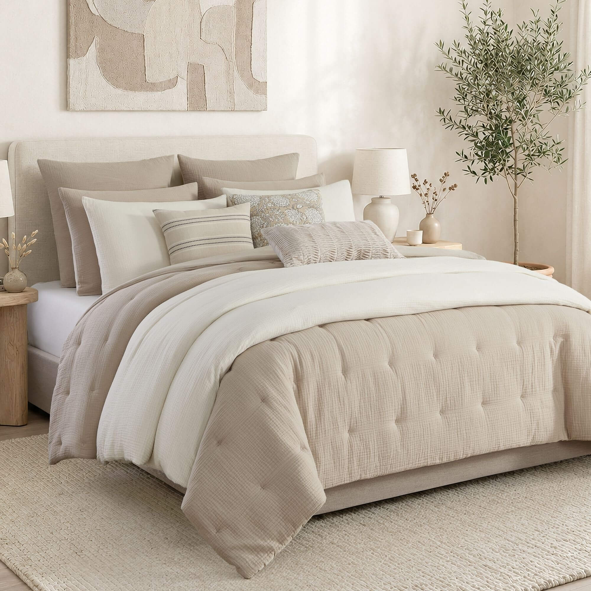 Neatly made bed with beige and white bedding in a bedroom setting.