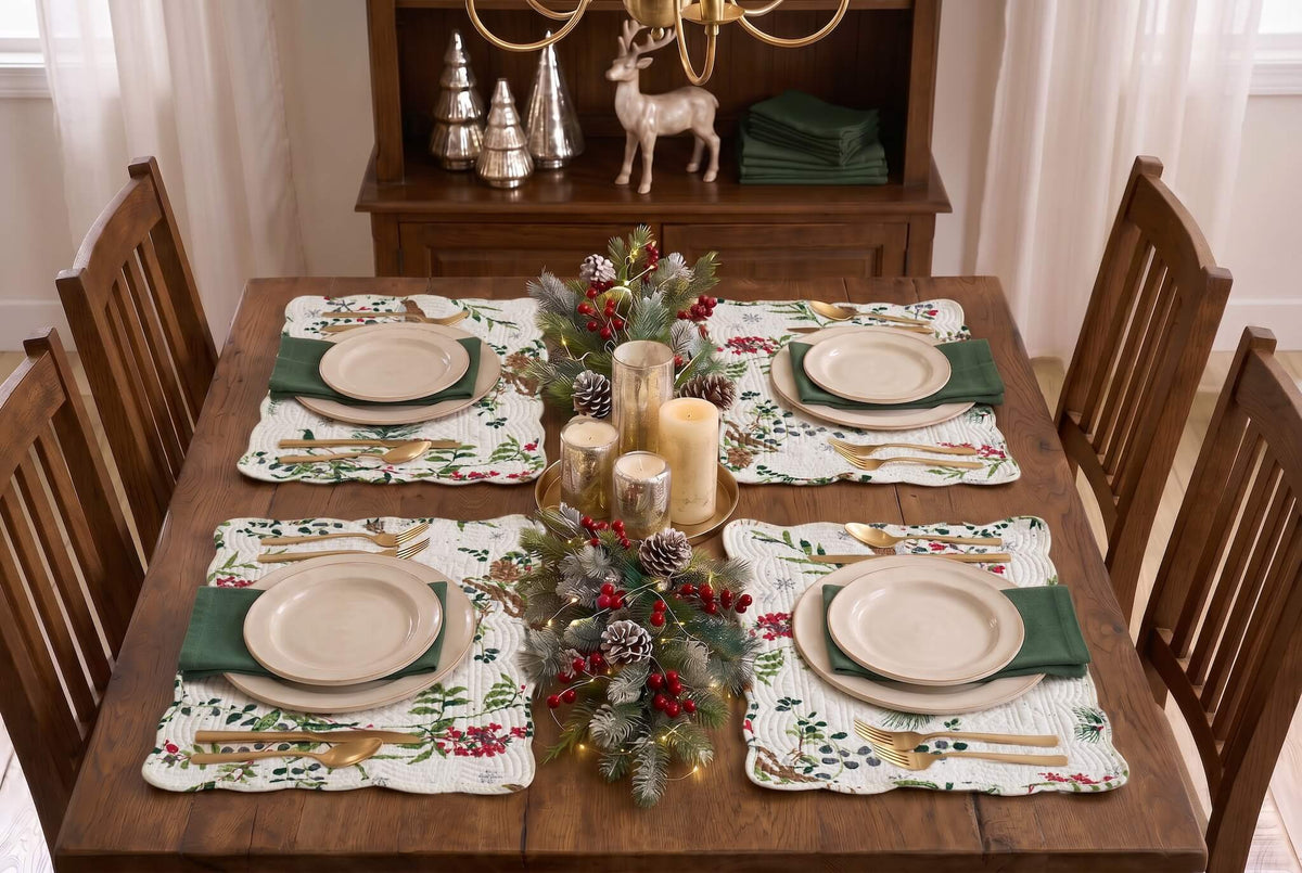 Four holiday-themed placemats with a rustic deer and berry pattern, styled on a dark wood dining table.