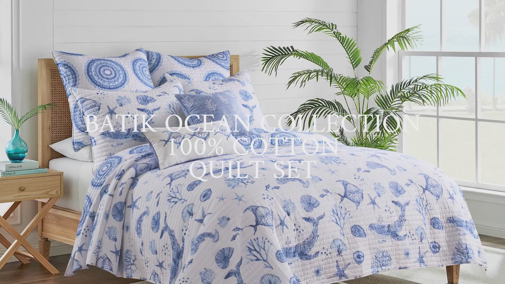 Video featuring a quilt set with sea life motifs in deep indigo against crisp white, with overlaid text: “Batik Ocean Collection – 100% Cotton Quilt Set.”